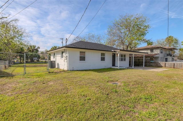 rear view of property with a yard and a patio