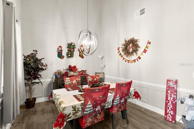 dining room with a notable chandelier and dark hardwood / wood-style flooring