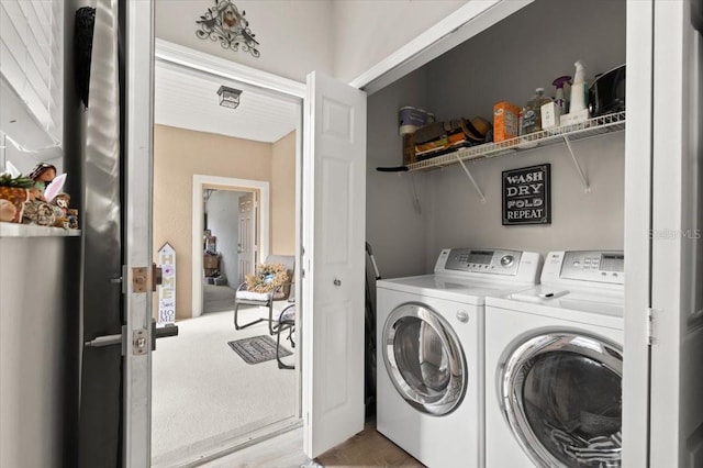 laundry area with washing machine and dryer and wood-type flooring