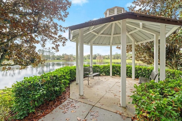 view of patio with a gazebo and a water view