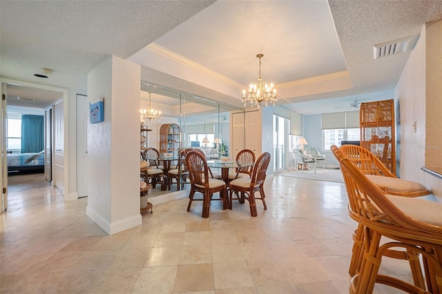 dining area featuring ceiling fan with notable chandelier, ornamental molding, a textured ceiling, and a wealth of natural light