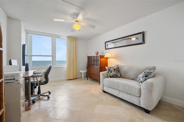 office featuring ceiling fan and a textured ceiling