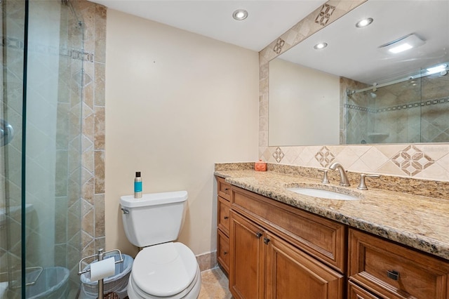 bathroom with vanity, toilet, and a shower with shower door