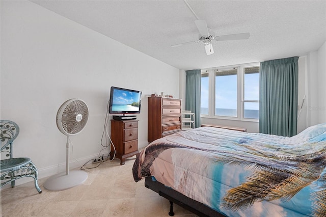 bedroom with a textured ceiling and ceiling fan