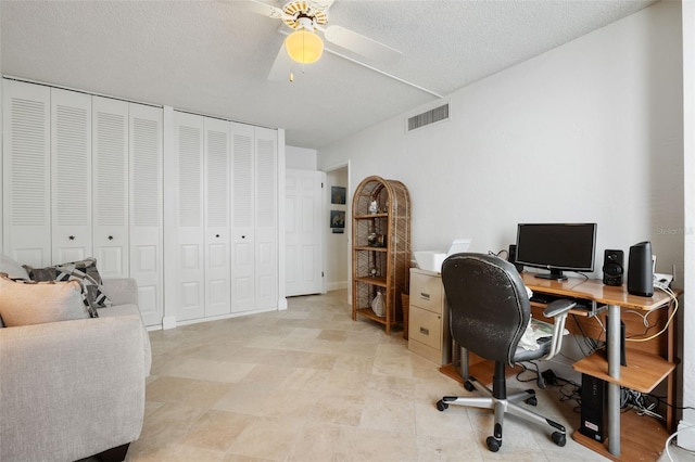 office featuring ceiling fan and a textured ceiling