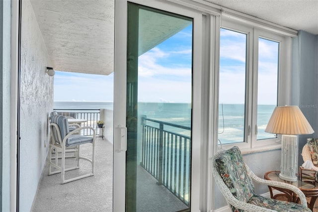 balcony featuring a water view