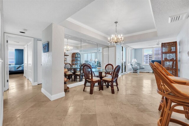 dining area with a textured ceiling, ceiling fan with notable chandelier, and crown molding