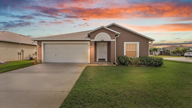 ranch-style house with a yard and a garage