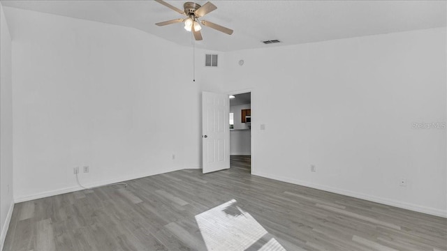 unfurnished room with light wood-type flooring, vaulted ceiling, and ceiling fan