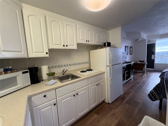 kitchen with sink, tasteful backsplash, dark hardwood / wood-style flooring, white appliances, and white cabinets