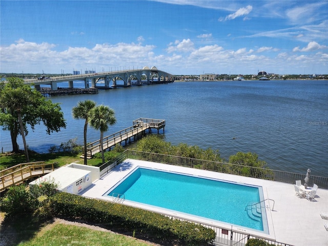 view of swimming pool with a water view