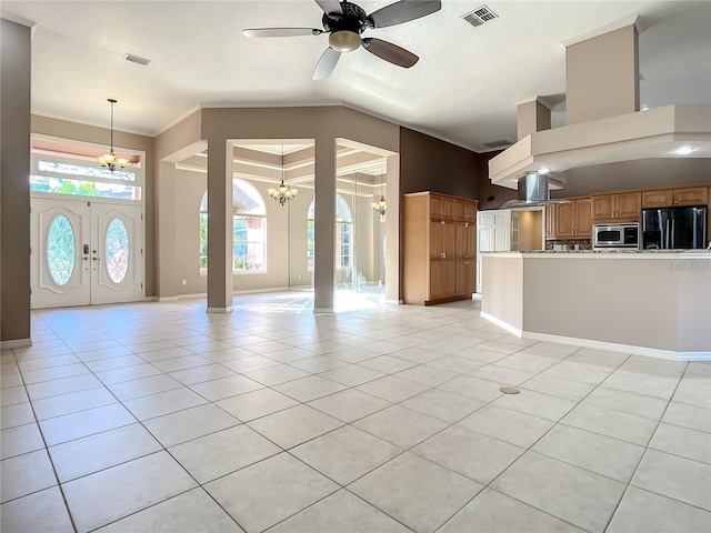 interior space featuring light tile patterned floors, ceiling fan with notable chandelier, and high vaulted ceiling