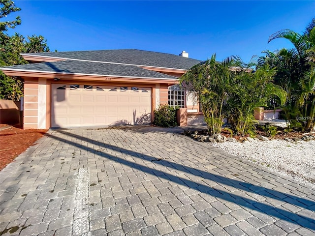 ranch-style house featuring a garage