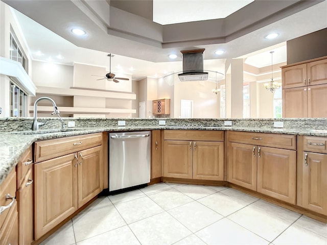 kitchen with light stone countertops, dishwasher, sink, pendant lighting, and ceiling fan with notable chandelier