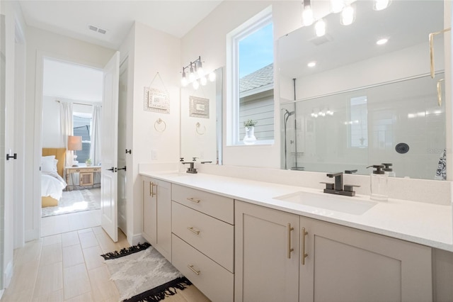 bathroom with tile patterned floors, vanity, and tiled shower