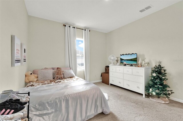 bedroom featuring light colored carpet