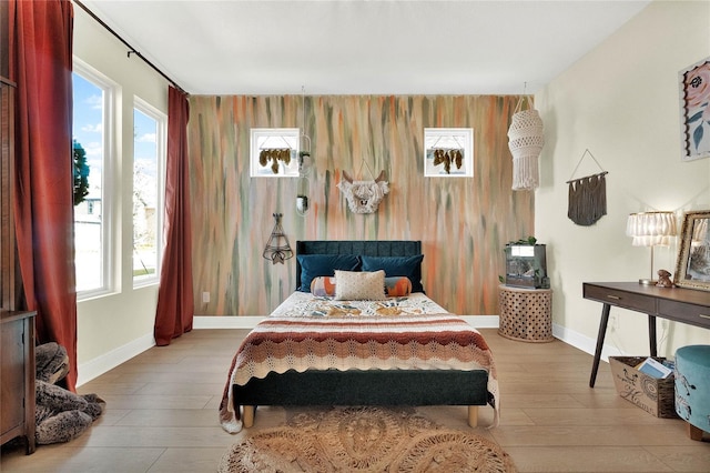 bedroom featuring light wood-type flooring and multiple windows