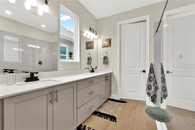 bathroom featuring a shower, vanity, and hardwood / wood-style flooring