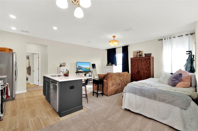 bedroom with stainless steel refrigerator and sink