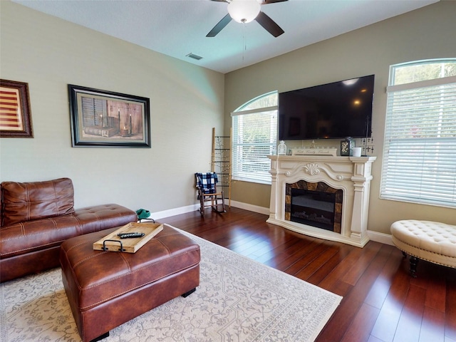 living room featuring ceiling fan and dark hardwood / wood-style floors