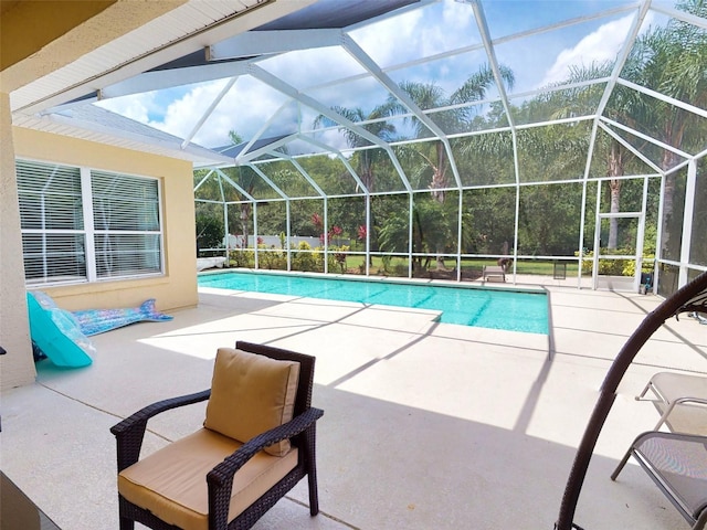 view of swimming pool with a lanai and a patio