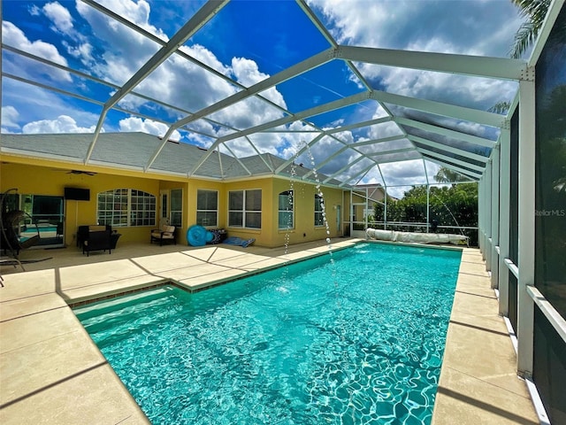 view of pool with a patio area, a lanai, and ceiling fan