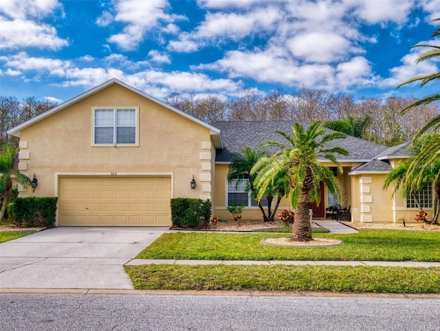 view of front of property featuring a garage and a front lawn