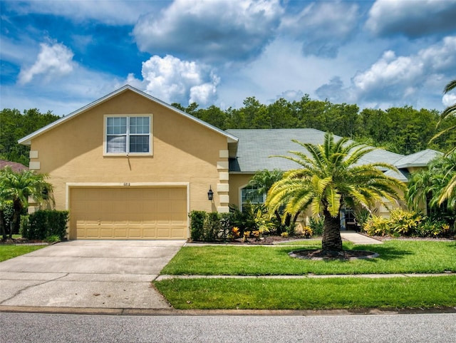 view of front of house with a garage and a front yard