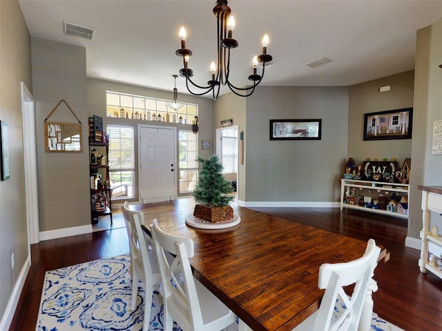 dining area featuring dark hardwood / wood-style flooring and a notable chandelier