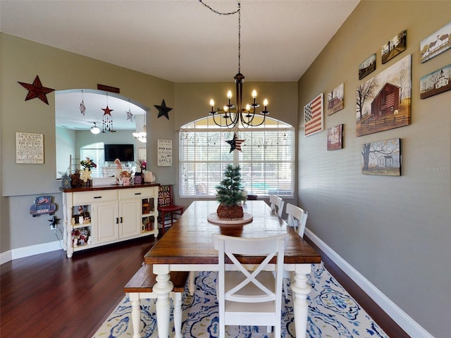 dining area featuring dark hardwood / wood-style flooring and a chandelier