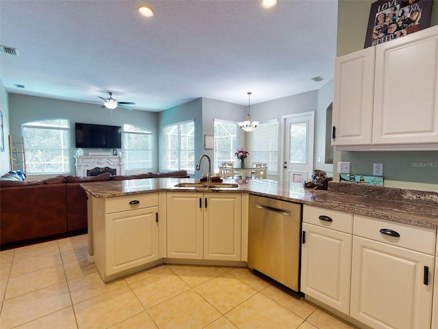 kitchen with dishwasher, sink, hanging light fixtures, white cabinets, and ceiling fan with notable chandelier