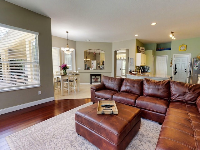 living room with a notable chandelier and hardwood / wood-style floors