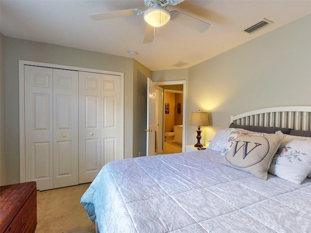 carpeted bedroom featuring a closet and ceiling fan