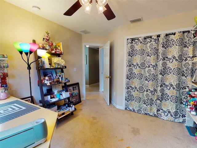 bedroom with ceiling fan and light carpet