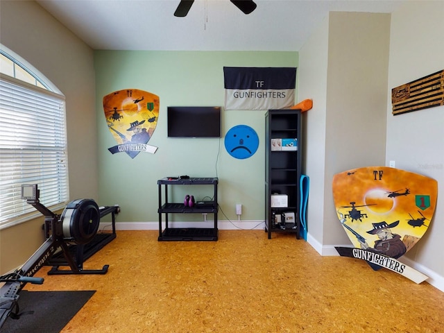 workout area with ceiling fan and carpet