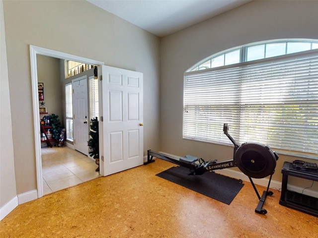 exercise room with light tile patterned floors