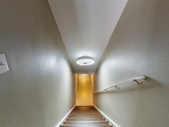 stairs featuring hardwood / wood-style floors