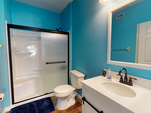 bathroom with walk in shower, vanity, toilet, and hardwood / wood-style floors