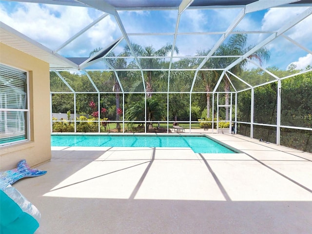 view of swimming pool with a lanai and a patio area