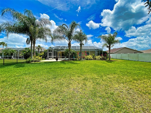 view of yard featuring glass enclosure