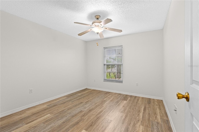 empty room featuring a textured ceiling, light hardwood / wood-style flooring, and ceiling fan