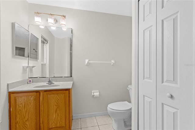 bathroom featuring tile patterned flooring, vanity, and toilet