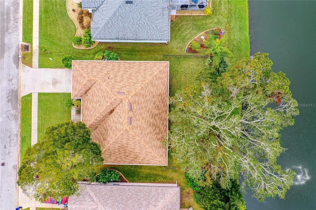 birds eye view of property with a water view