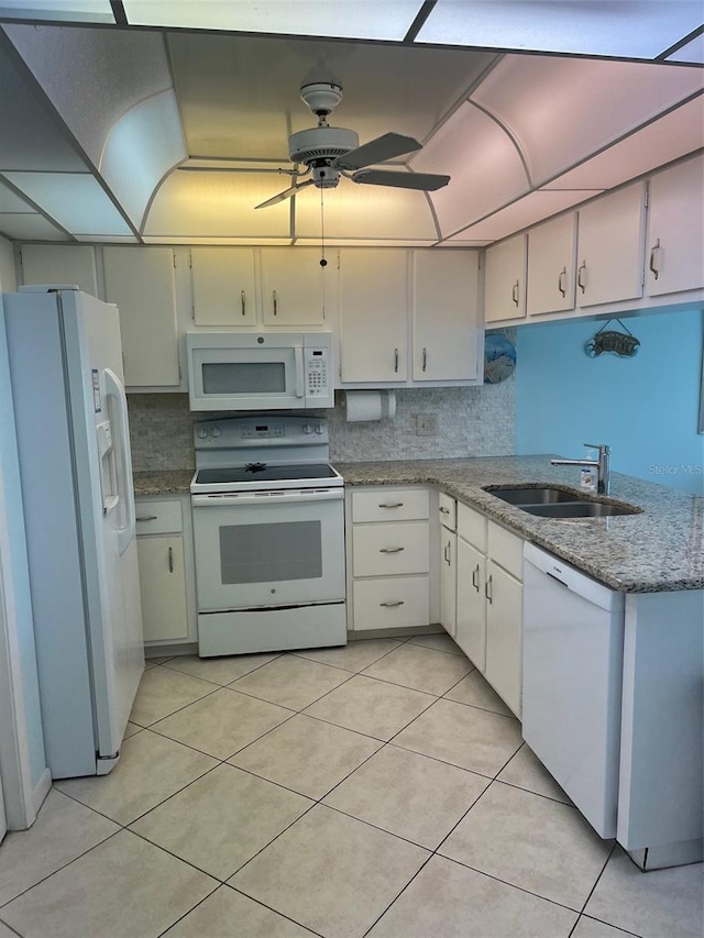 kitchen featuring white cabinets, white appliances, sink, and light tile patterned floors