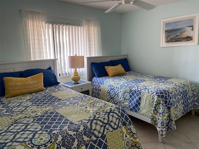 bedroom with ceiling fan and light tile patterned flooring