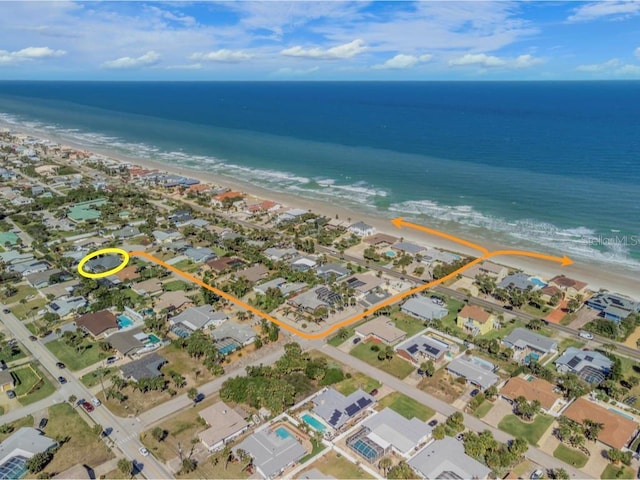 aerial view featuring a water view and a beach view