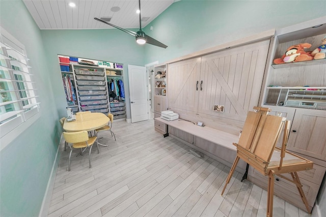 interior space with ceiling fan, light hardwood / wood-style floors, wood ceiling, and high vaulted ceiling