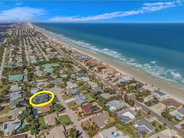 birds eye view of property with a view of the beach and a water view