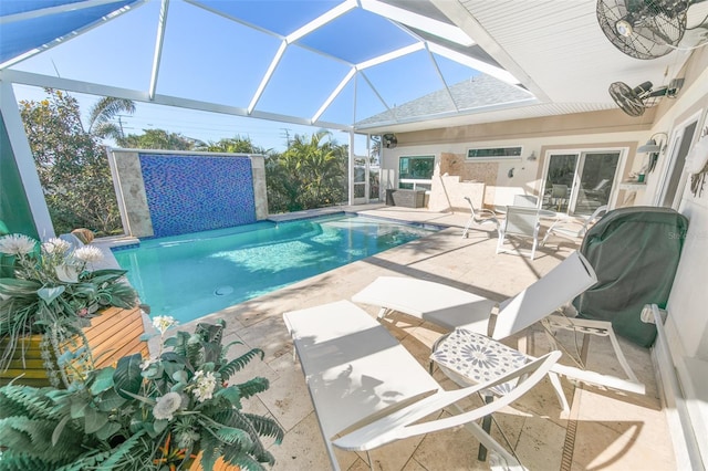 view of swimming pool with a patio area and glass enclosure