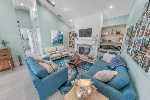 living room with high vaulted ceiling, light wood-type flooring, built in features, a fireplace, and wood ceiling